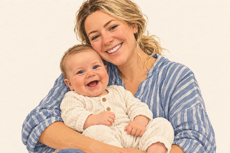 A mother in a blue striped shirt cuddles her smiling baby.